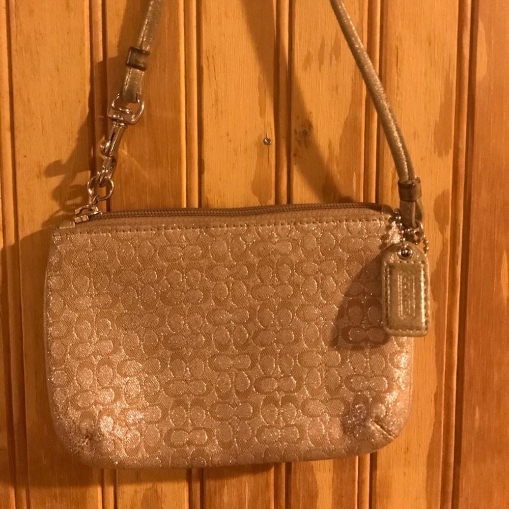 Coach wristlet. Gold classic Coach pattern.